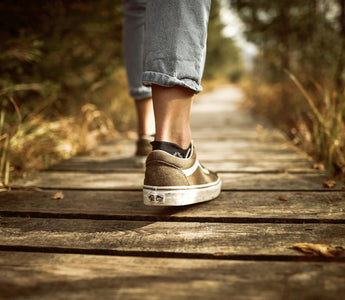 A persons feet as they walk mindfully.